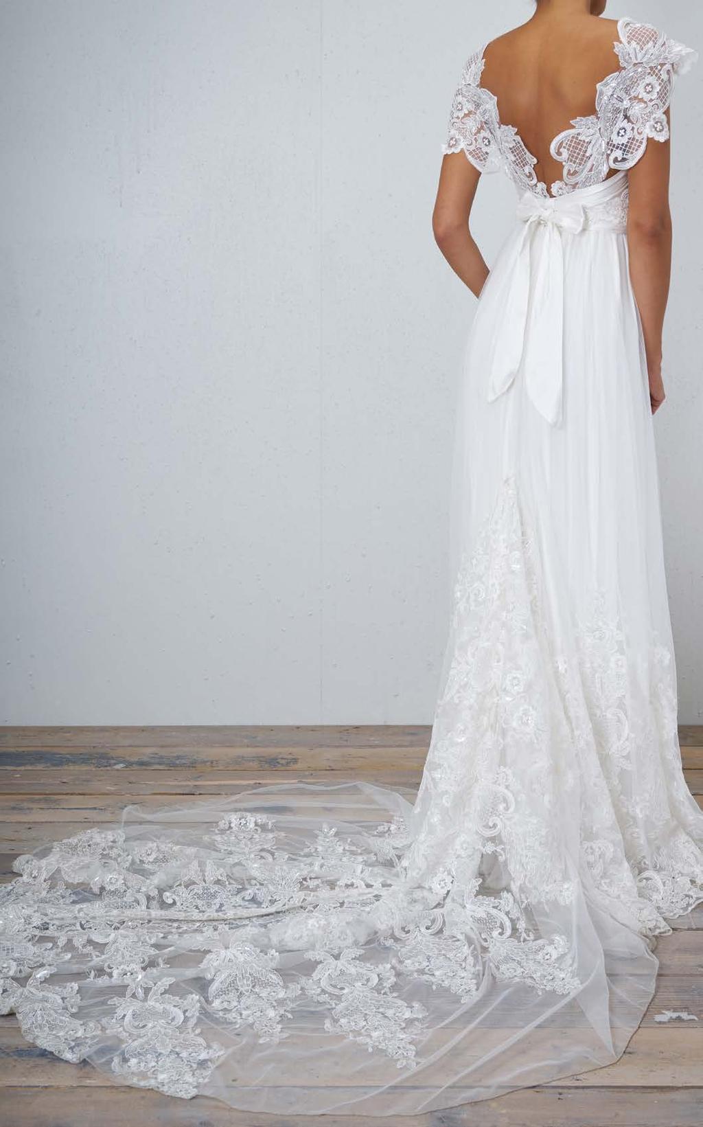 Full, ethereal silk tulle is softly accented with an ivory embroidered lace overlay.