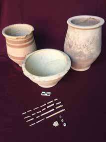 amounts of ceramics, along with a basalt grinding stone and large stone pestle.