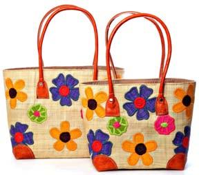 M24 Pretty raffia baskets with our appliqué flower design on both sides, each basket has leather handles and base corners, an inside pocket and a