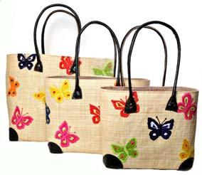 with appliqué colourful butterflies on both sides, each basket is finished with leather handles and base corners, an inside pocket and coordinated