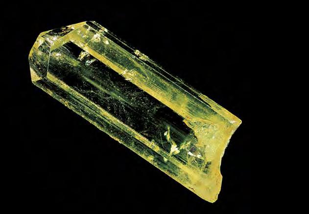 Figure 12. In addition to aquamarine, the deposit also produces fine crystals of yellow beryl, like this 3.4 cm specimen. Johannesburg Geological Museum specimen no. 65/116; photo Bruce Cairncross.