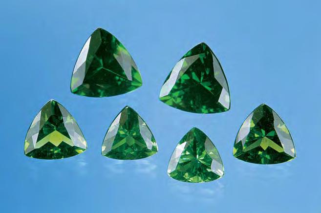 Figure 7. These six modified triangular brilliants (2.05 4.93 ct) were represented as natural green obsidian, but they proved to be manufactured glass. Moldavite, Journal of Gemmology, Vol. 24, No.