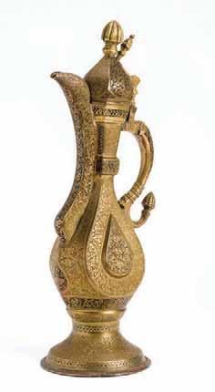 On the foot, leading up to the body and on the neck are multitudes of inscriptions in nasta liq. Fine and rare composition. 264 A FINE BUKHARA TEAPOT Brass and copper.