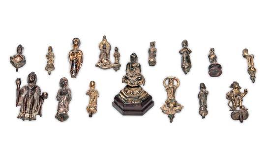 61 Fifteen Buddhist Gilt-bronze and Bronze Miniature Items, China, a gilt-bronze Buddha seated on a lotus throne above an elongated hexagonal multi-tier pedestal, mounted on a wood stand; six finials