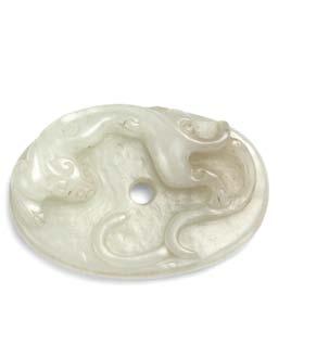 166 167 166 Jade Toggle, China, 18th/19th century, oval decorated with a carved chilong on one side and incised ruyi design on the other, celadon stone with white inclusions, dia. to 2 in.