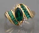 Page: 4 26A EMERALD AND DIAMOND RING -10k yellow gold (3.9g) set with one marquis synthetic emerald (0.