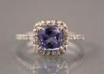 5 43 TANZANITE AND DIAMOND RING - A 10K white gold ring with one cushion faceted tanzanite (1.