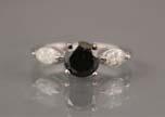 Page: 6 46 BLACK DIAMOND RING - A 14K white gold ring with one treated black round brilliant cut diamond (1.