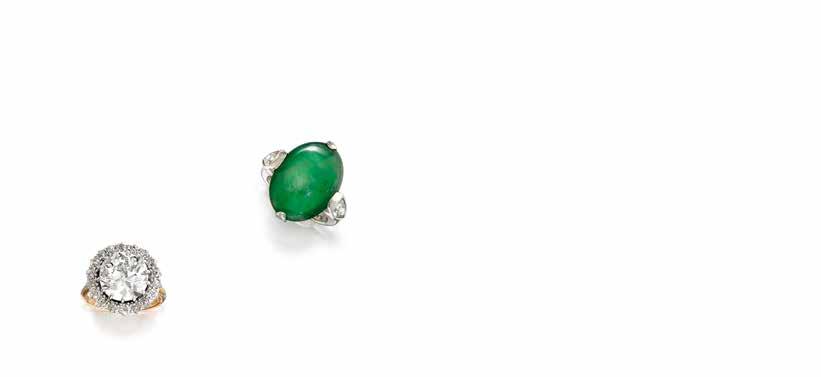 71 71 A JADEITE JADE AND DIAMOND RING centering a cabochon jadeite jade, measuring approximately 5.5 x 21.8 x 4.