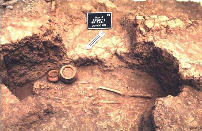 Pit #6, Feature #1 (lot #12) This is a shaft-and-chamber tomb with the shaft on the south side and a burial, probably of an adult, (measuring 165 cm long, but with the bones very damaged by the