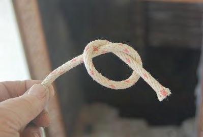 Pull the upper sash weight up in the cavity and retain it with a new détente knot. Tie an overhand knot in the end of the upper sash cord. Repeat the above process for the second upper sash cord.