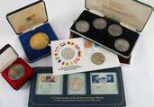 A collection of modern silver and other coins and medallions, including a sterling silver proof like set of four 1972 Olympic coins, two 1974 Panama 20 Balboas