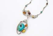 414. A modern stylish white metal turquoise and amber necklace, the pendant with sinuous lines and set with a large turquoise stone with matching lower