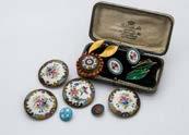 568. A set of four large early 20th century enamelled buttons, together with a pair of enamel earrings, in a box, two