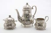 73. A mid to late 19th century German silver three piece bachelors tea set, rococo themed comprising