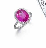 105 106 105 A RUBY AND DIAMOND RING The cushion-shaped ruby within a brilliant-cut diamond surround and mount, ruby approximately 5.