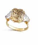 22 carats, between triangularcut diamond shoulders, ring size R 40,000-60,000 US$62,000-93,000 Accompanied by a report from GCS stating that the diamond is Fancy Intense Brownish Yellow, natural