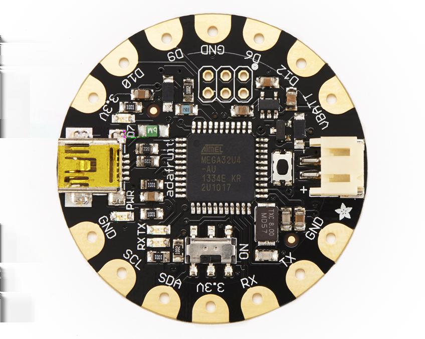 Figure P-1. FLORA main board The 14 pads are laid out to make it easy to connect sensors like a sewable motion sensor, a color sensor, the FLORA Ultimate GPS module, or the FLORA light sensor.