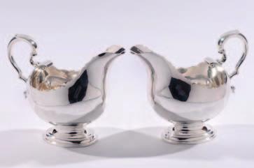 on four swept feet, with two clear class and silver mounted ink wells, maker Edward John Haseler & Noble