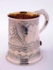 A George III mug of tapering cylindrical form, scroll handle, and embossed with a portrait of King Charles
