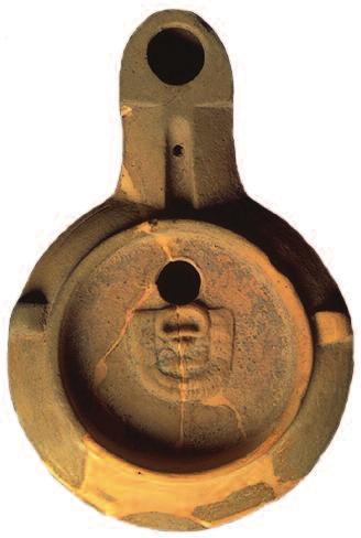 4Oil lamp with medallion showing a theatre mask discovered in the Pauvadou necropolis in Fréjus (Photograph by P. Foliot).