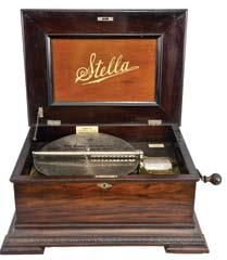 5 inch music box with 10 discs, oak case with stepped ogee base and locking drawer, rope molding, stepped, molded lid, the inside with music-themed