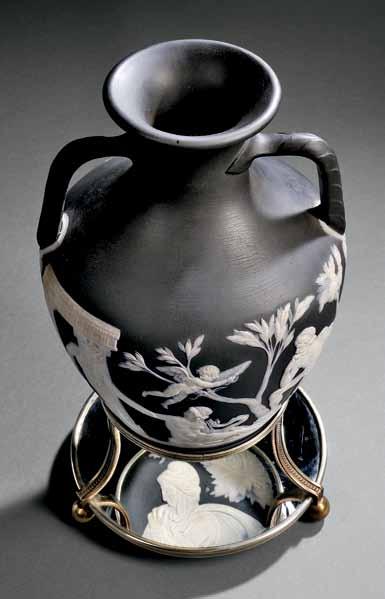 $3,000-5,000 153 Wedgwood Black Jasper Dip Portland Vase, England, 19th century, applied white classical figures in relief, a man