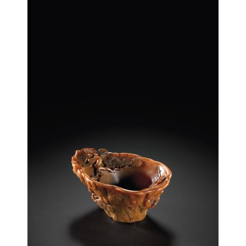 Rhinoceros Horn Carvings from The Edward Hong Kong 08 Apr 2011, 10:00 AM HK0370 LOT 2712 A SMALL 'PINE' RHINOCEROS LIBATION CUP 17TH CENTURY the wide shallow cup of irregular form carved on the