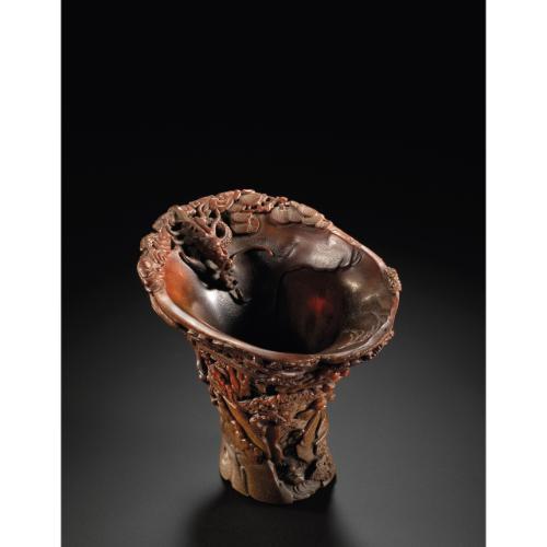 Rhinoceros Horn Carvings from The Edward Hong Kong 08 Apr 2011, 10:00 AM HK0370 LOT 2714 A FIGURAL LANDSCAPE RHINOCEROS HORN LIBATION CUP QING DYNASTY, 17TH / 18TH CENTURY the tall horn carved on the