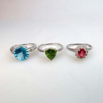 169 THREE ENGLISH 9K WHITE GOLD RINGS set with peridot, red spinel, white