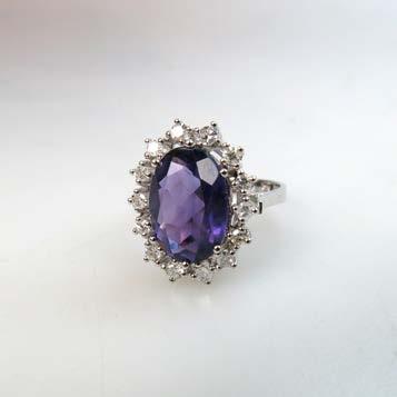 295 18K WHITE GOLD RING set with an oval cut amethyst encircled by 14 small