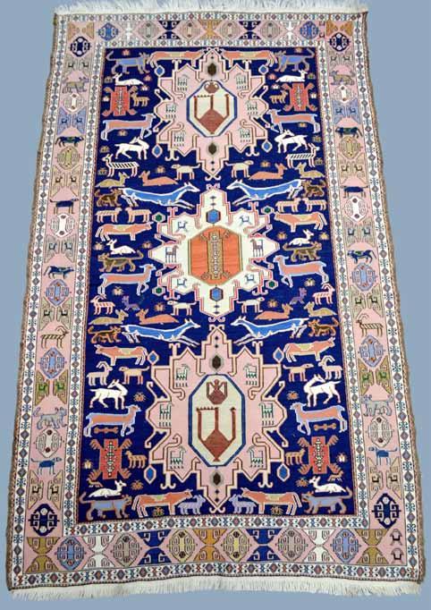 1148 Persian blue ground rug, multiple borders, main blue border, centre with floral motifs and central shaped ivory ground medallion, 160cm x 109cm 400-600 1149 Sumak Persian vegetable dyed wool rug