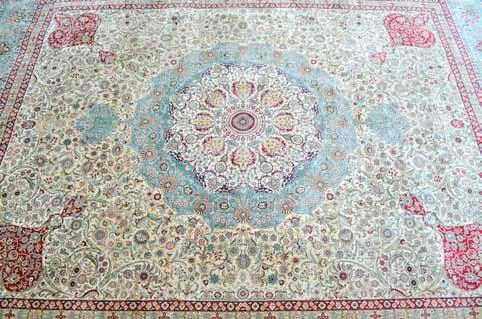 Afghan red ground carpet with multiple borders, centre with eighteen octagonal shaped medallions, 352cm x 244cm 100-200 1152 Cream ground silk carpet with multiple borders, the main in pale blue,