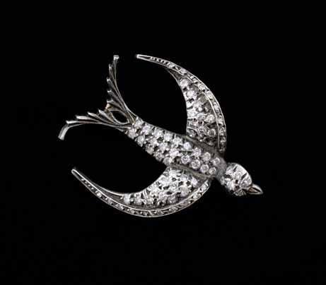 151 A diamond set swallow brooch, set with round brilliant cut diamonds silver and gold mounted 1000-1500 152 A synthetic emerald and diamond ring, Step-cut synthetic emerald to centre flanked by two