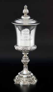 460 460 19th century German silver cup and cover with embossed decoration, knopped stem on shaped and filled base, 27.