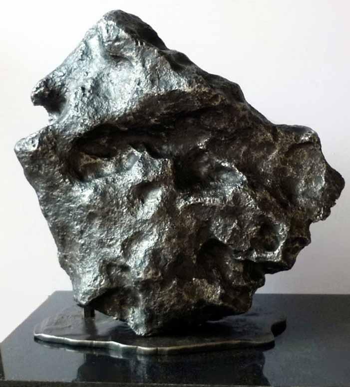 803 802 A custom made steel table (this was hand crafted by Utopia Forge to take the weight of the meteorite) 500-700 803 CAMPO DEL CIELO METEORITE 42kg (approx) 33cm x 35cm.