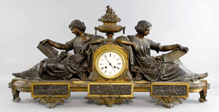 Gilt metal and onyx mantel clock with twin train movement striking on a bell. Height 40cm.