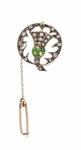 $400-600 75 a Victorian Silver topped Gold, demantoid Garnet and diamond thistle motif Pendant/ Brooch, containing six round mixed cut demantoid garnets measuring approximately 1.50-2.