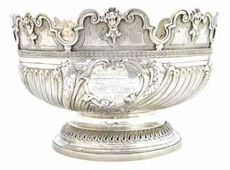 2050. A George III silver Monteith punch bowl, having a cast and shaped rim, decorated with masks and scrolls, the body with wrythen fluted decoration, with foliate sprays at intervals, raised on a