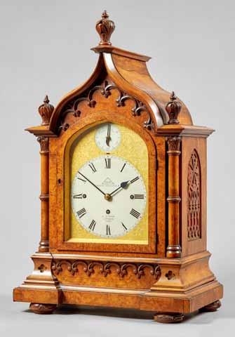 Lot 792 Lot 793 792. A Regency mahogany and brass-inlaid bracket clock The case with a chamfered pediment surmounted by a pineapple finial, above the 8in.