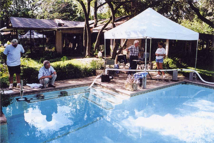 Figure 1 Test set-up in a residential pool. At left (arrow) is a suction fitting installed horizontally 6 inches below the surface of the pool.