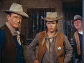in the American West enlists the help of a cripple, a drunk, and a young gunfighter in his efforts to hold in jail the brother of the
