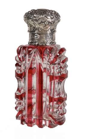 A Collection of Scent Bottles, Part I 59 A Victorian silver mounted ruby flash cut glass scent bottle, unmarked, mid 19th century, with a scroll foliate rounded hinged cover, a push thumbpiece, the