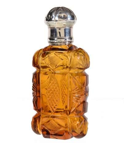 cover, the oblong section bottle deeply cut, 10cm (4in) high 61 A Victorian silver mounted amber cut glass scent bottle, unmarked, mid 19th century, with a lobed and punch beaded rounded pull-off