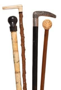 Walking Sticks 79 Ω Two Queen Anne or George I ivory mounted malacca walking sticks, early 18th century, the first with a baluster grip with simple linear