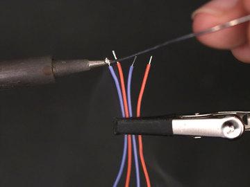 To keep the tips of wires from fraying, use the tip of the soldering iron to apply solder.