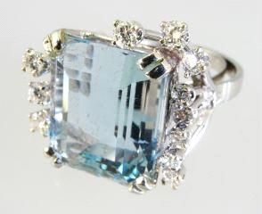 426 Ladies' 14k gold ring set with cluster style diamonds. 427 18kt. white gold emerald cut aquamarine dinner ring surrounded by diamonds.