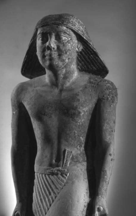 Figs. 3 4. Standing statue found near Khafre causeway. Length of right leg: 17.5 cm Length of left leg: 18.8 cm There are no inscriptions on the base, which has been painted black.