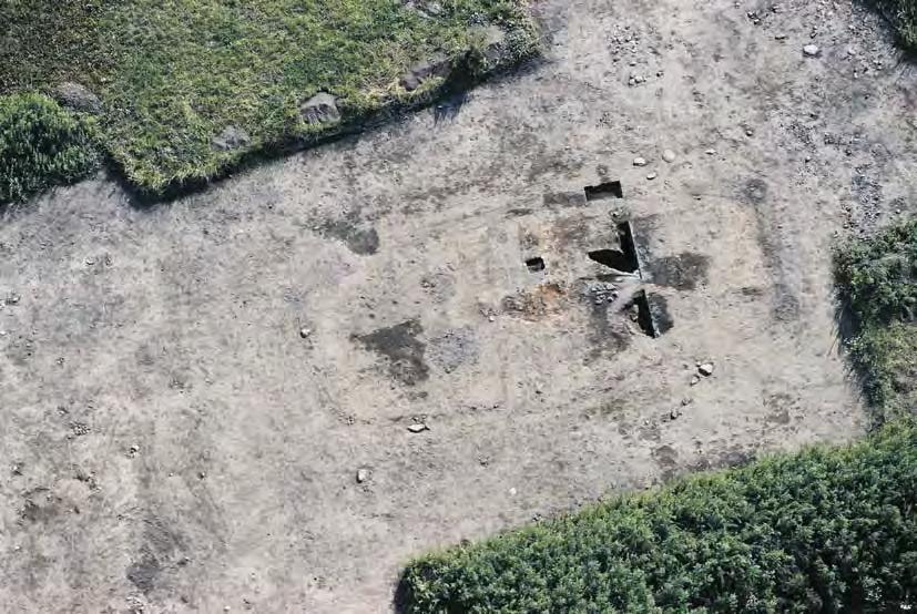 Fig. 1. Aerial photograph of the remains of the high timbered house. The photo was taken from east during summer 2001. The remains of the house are seen in the central view of the photo.