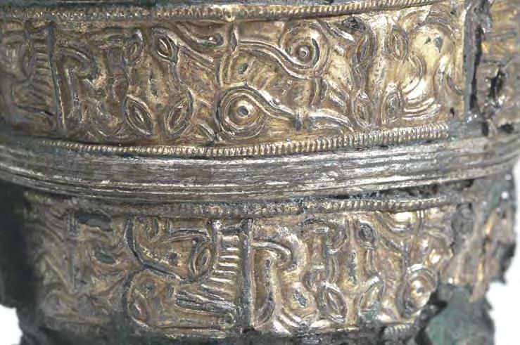 Fig. 6. Profiled silver bands, detail. Photo: Bengt Almgren, LUHM, Lund. Fig. 7. The rim of the beaker. Photo: Bengt Almgren, LUHM, Lund. zoomorphous motifs. The first panel (Fig.